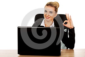 Young smile businesswoman behind the desk, using laptop