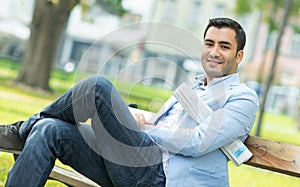 Young smile happy man sitting on bench