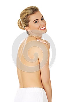 Young smile topless woman with white towel around her waist.