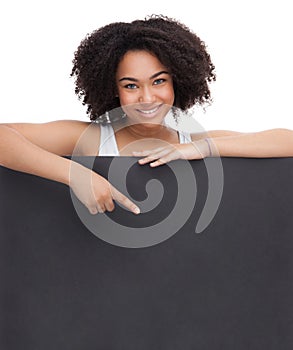 Young Smileing teenager african girl hold black blank paper and shows on it.