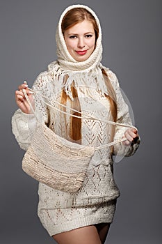 Young smiling beautiful stylish blonde woman in white knitted sc