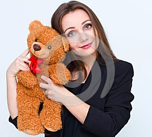 Young smiling beautiful woman holding teddy bear