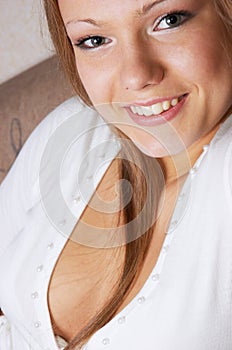 Young smiling beautiful woman in white photo