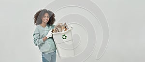 Young smiling black girl hold bin with cardboard