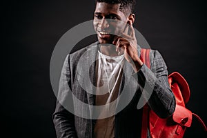 Young smiling black guy is talking with his girlfriend with headphones