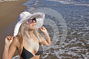 Young smiling blond woman on a beach