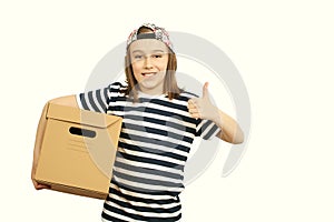 Young smiling boy holding the box on white background. Child with carton package. Delivery Concept