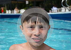 Young smiling boy in a swimming