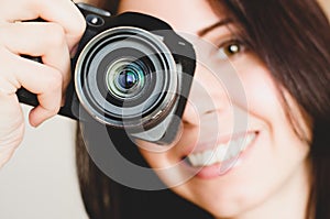 Young smiling brunette girl with camera