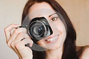 Young smiling brunette girl with camera