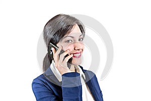 Young smiling brunette girl talking by a smartphone. cellular ph