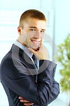 Young smiling business man standing