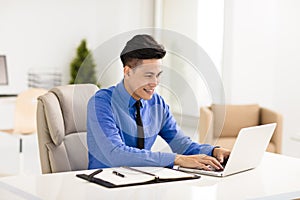 Young smiling business man working in office