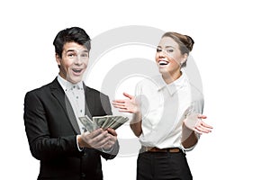 Young smiling business people holding money