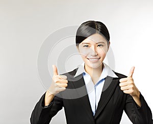 Young smiling business woman with thumb up gesture