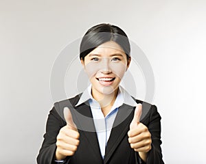 Young smiling business woman with thumb up gesture