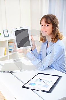 Young smiling business woman using a tablet