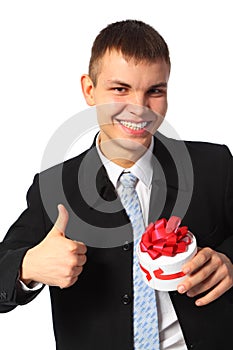 Young smiling businessman with gift box