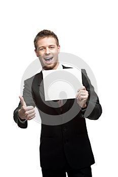 Young smiling businessman holding sign