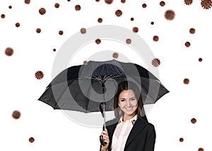 Young smiling businesswoman under umbrella among coronavirus cells.