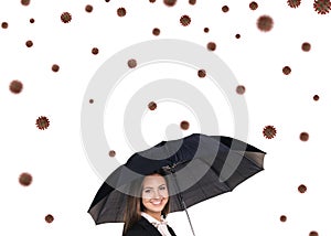 Young smiling businesswoman under umbrella among coronavirus cells.