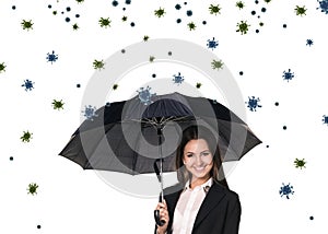 Young smiling businesswoman under umbrella among coronavirus cells.