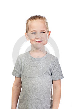 Young smiling caucasian boy with lollipop in mouth