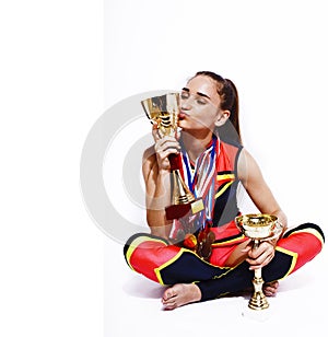 young smiling cheerleader girl with golden cups and price medals isolated on white background, lifestyle sport people