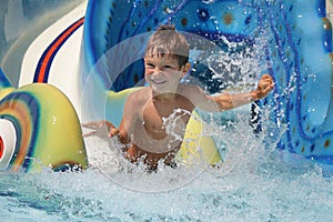 Young smiling child having fun in aquapark