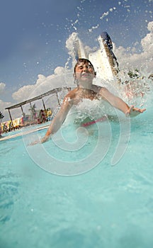 Young smiling child having fun on aquapark