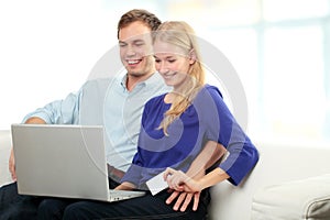 Young smiling couple shopping on internet