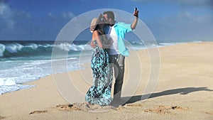 Young Smiling Couple Taking Selfie On Beach
