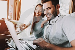 Young Smiling Couple Using Laptop in Tour Bus