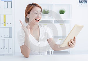 Young smiling employee business woman watching the tablet pc