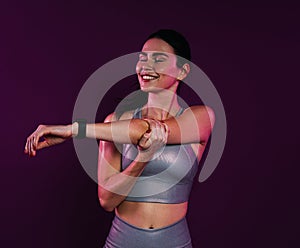Young smiling female with closed eyes stretching and flexing her hands