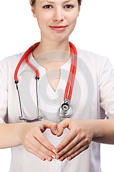 Young smiling female physician in doctor's smock with stethoscop