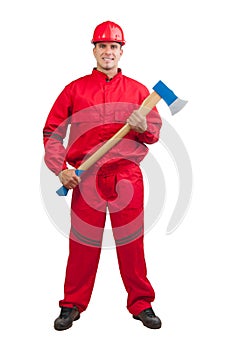 Young smiling fireman with hard hat with ax