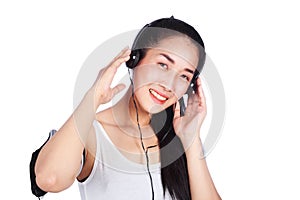 Young smiling fitness woman listening to music with earphones is