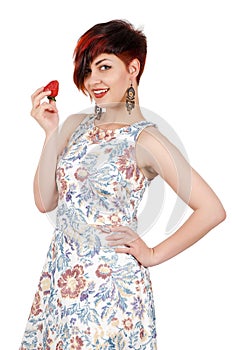 Young smiling girl eating strawberries.