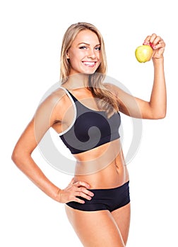 Young smiling girl holding green apple in hand