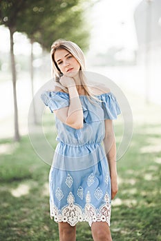 Young smiling girl outdoors portrait. Soft sunny colors