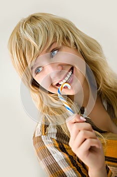 Young smiling girl with sugar candy