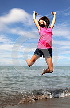 Young Smiling Girl Taking a Super High Jump For Joy Happiness Ov