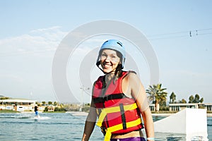 Young smiling girl on wake board in water, happy lifestyle people on vacations