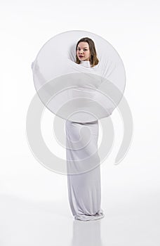 A young,smiling girl in white conceptual dress .