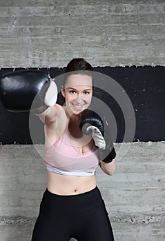 A young smiling girl. Who is a big fan of sports and especially boxing