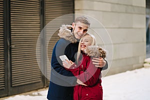 Young smiling happy european couple hugging in winter