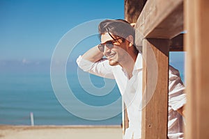 Young smiling happy man on beach vacation