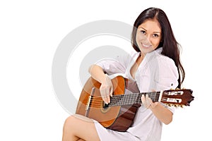 Young smiling lady playing acoustic guitar