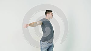 Young smiling man athlete doing warming exercises on white background. Concept of sport, health, keeping fit